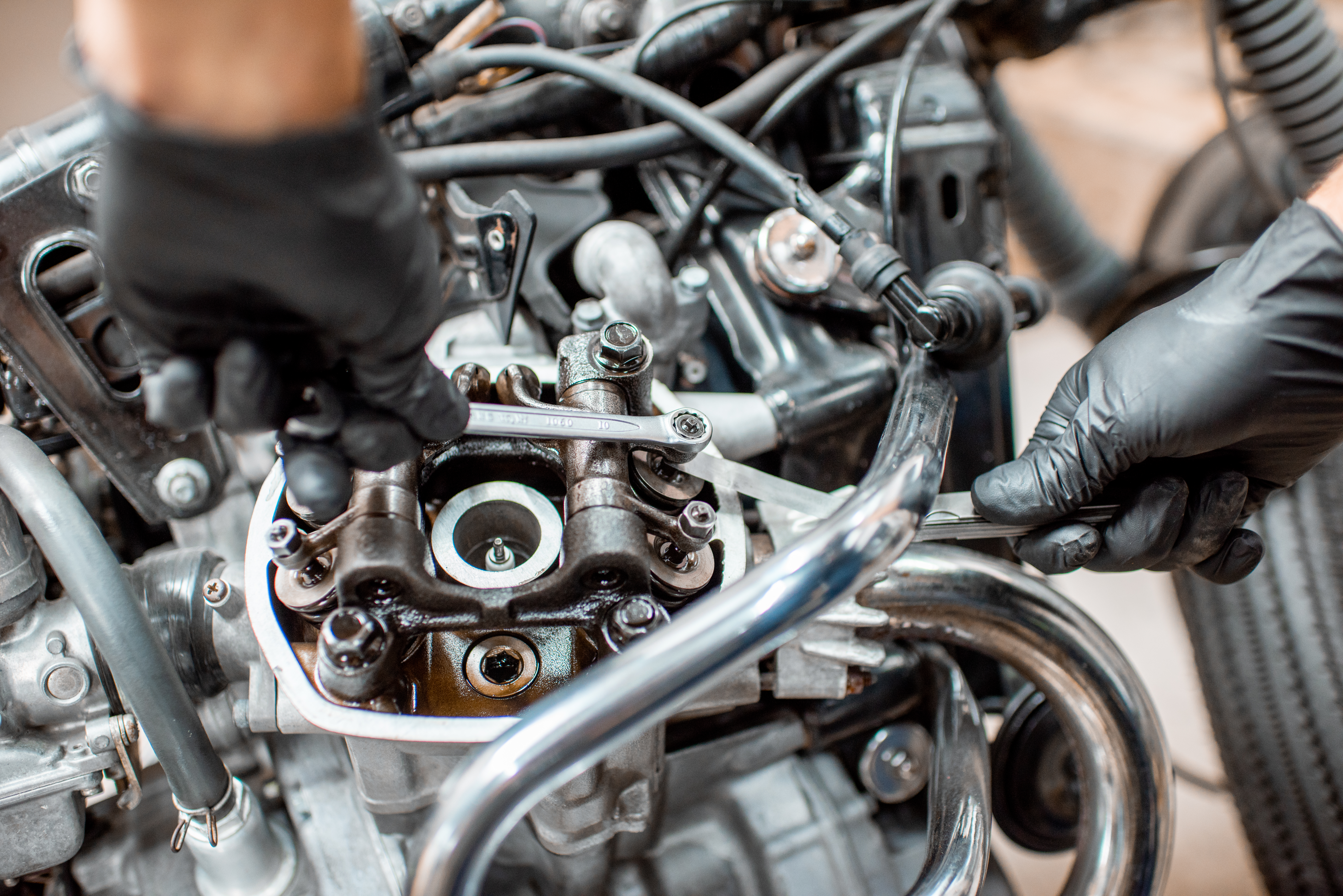 Mechanic repairing a motorcycle engine in the workshop